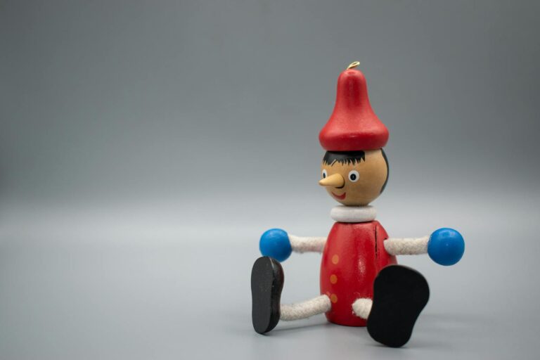 A Wooden Pinocchio Toy in Close-Up Photography